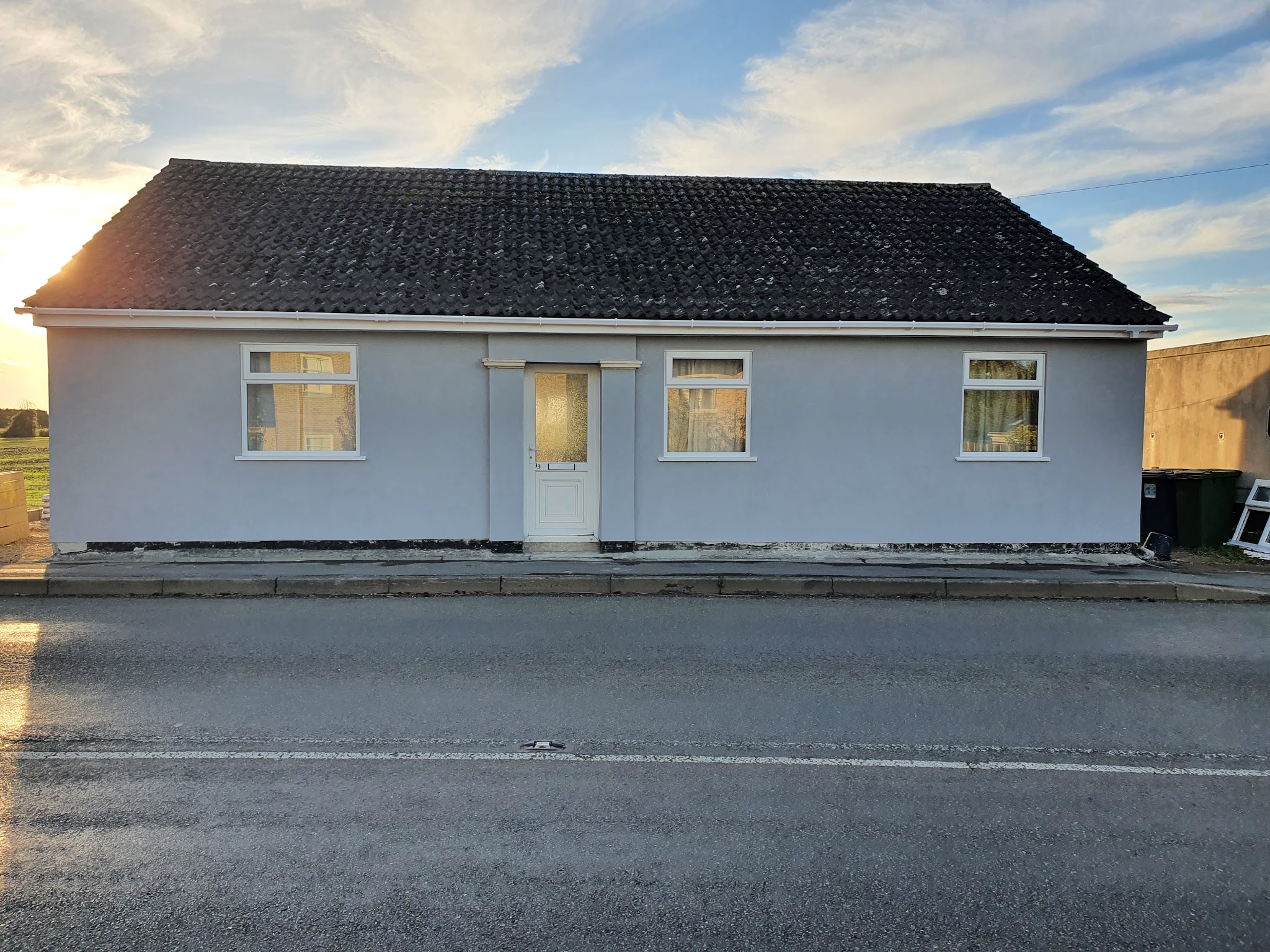 Detached bungalow re-rendered in pale blue-grey