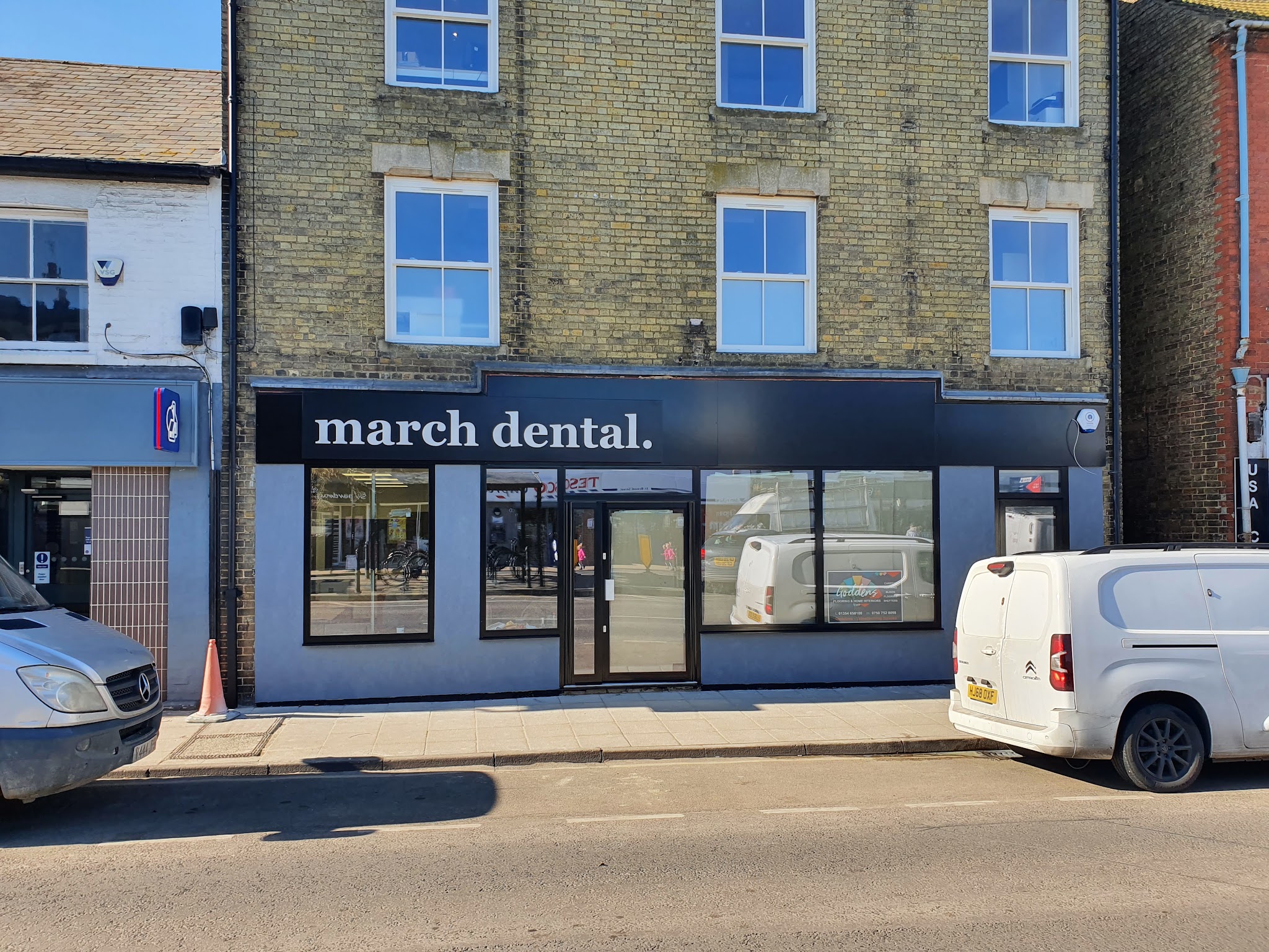 Shopfront with the ground floor rendered in grey-blue